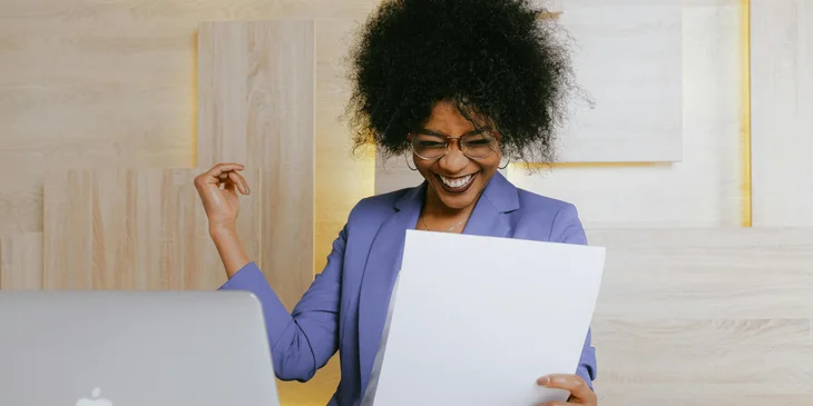 A woman holding a paper.