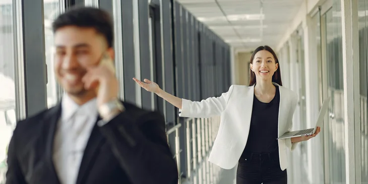 A cheerful coworkers standing in a modern office.