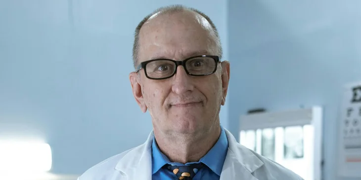 A male doctor in a white coat.