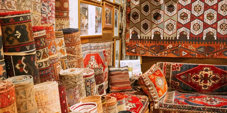 Rolls of carpet piled side by side in a store.