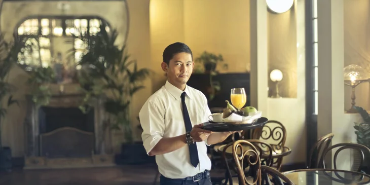 A waiter holding a tray.