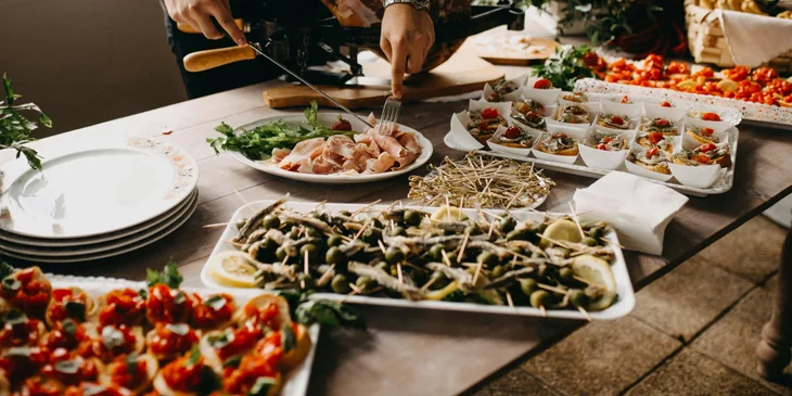 A caterer preparing food for the guests.