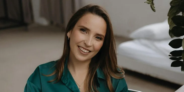 A woman wearing a green top.