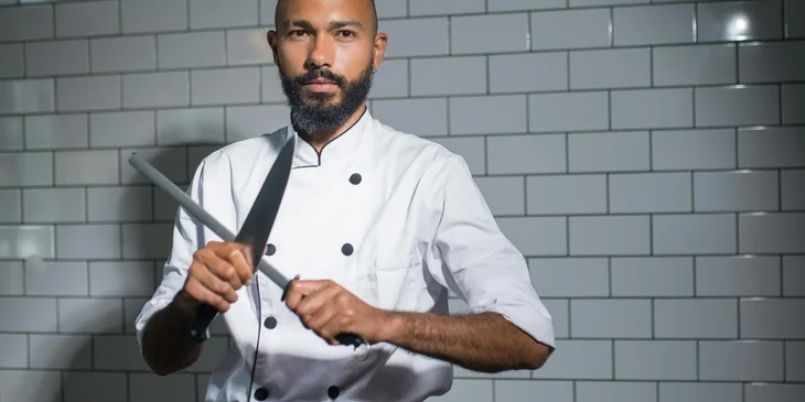 A chef holding a knife.
