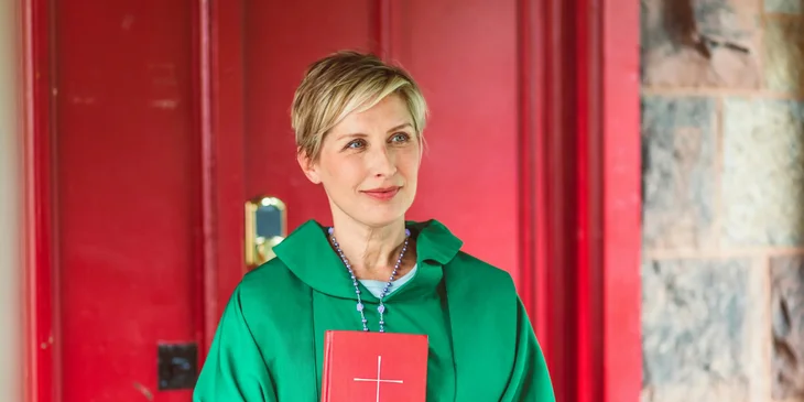 A priestess holding a bible.