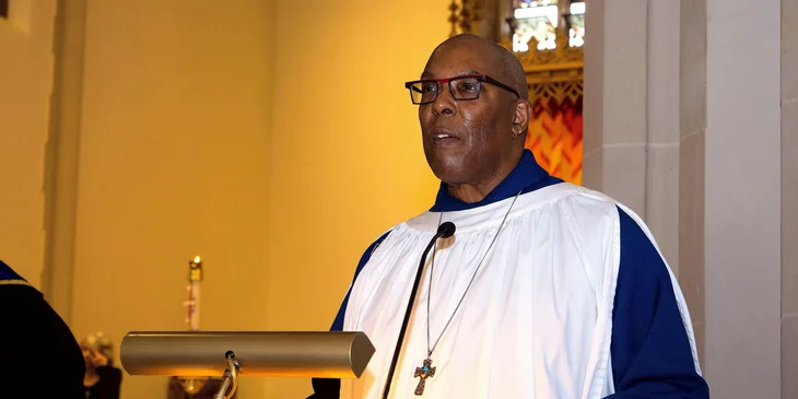 A pastor standing at a podium.