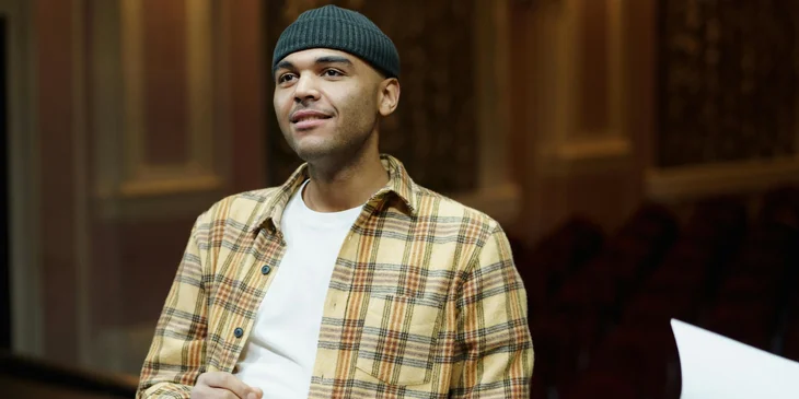 A man wearing a plaid shirt and a knit cap.