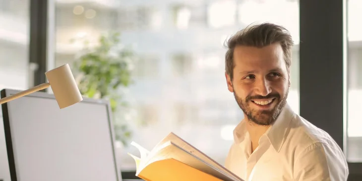 A man holding a book.