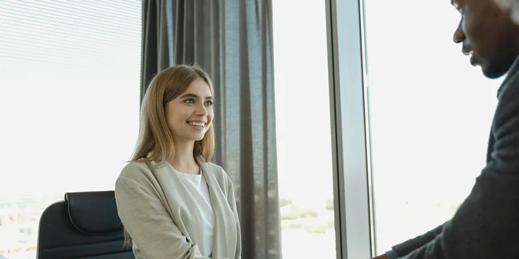 A newly hired employee shaking hands with an HR representative.