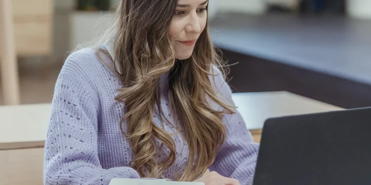 A woman on a laptop concentrating on a project.
