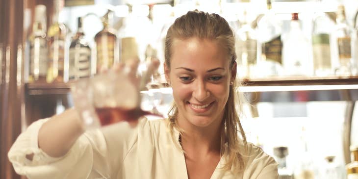 Cocktail Waitress getting ready to serve a drink to a valued customer.