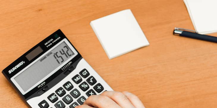 A commercial underwriter calculating risk,