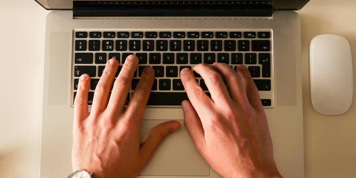 A person typing on a laptop.