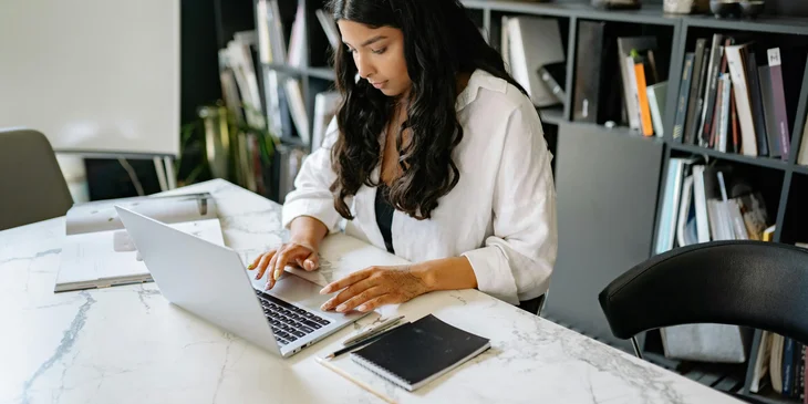 A woman working on her laptop.