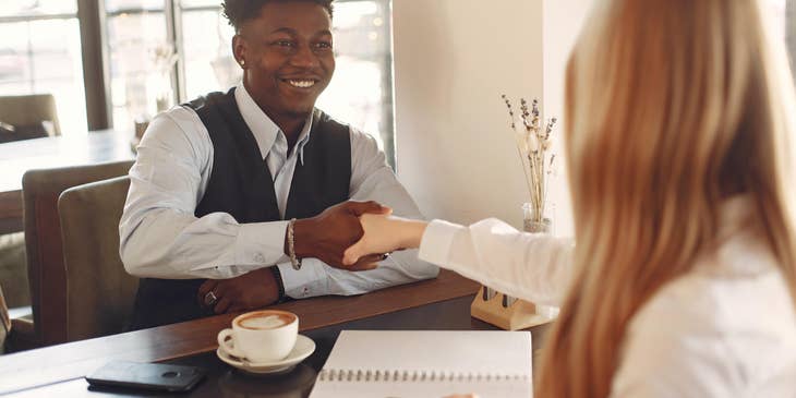 Man shaking hands with a woman at an interview