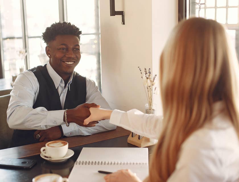 Man shaking hands with a woman at an interview