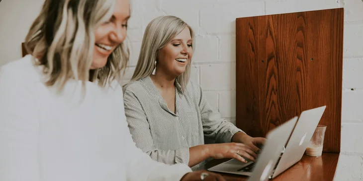 Two women working together.