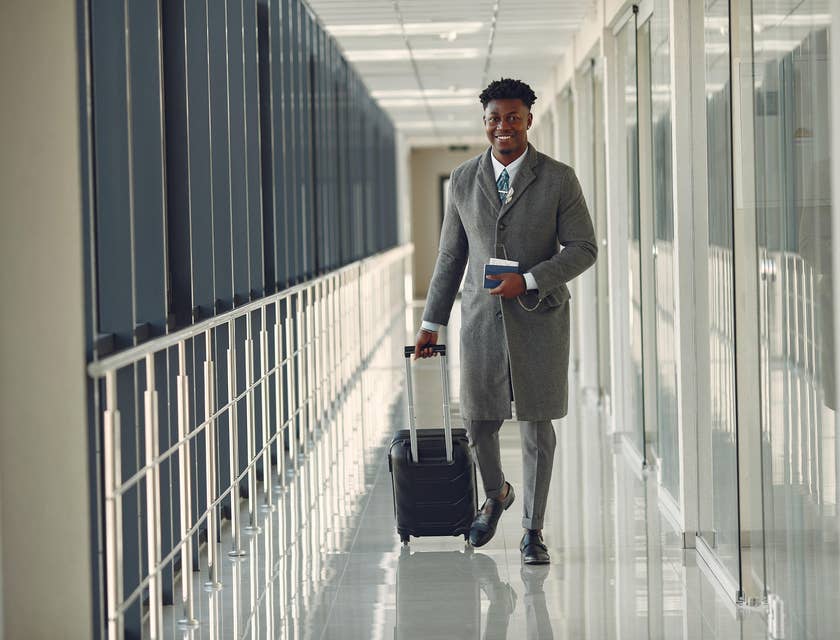 Man in an airport carrying luggage