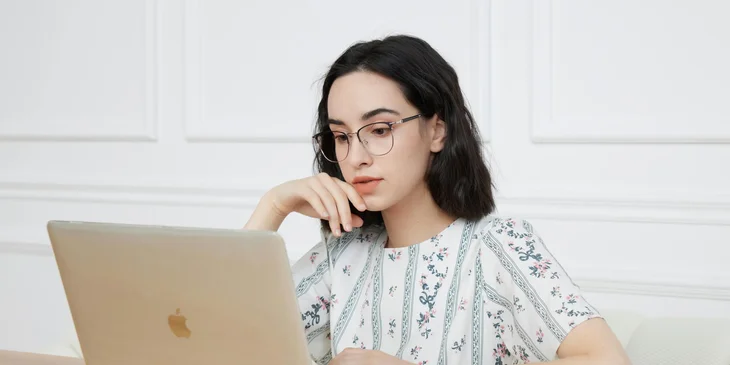 A woman working on her laptop.