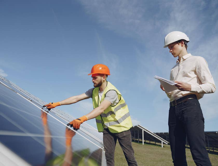 A compliance technician inspecting solar panels.
