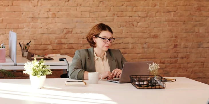 A woman working on her desk.