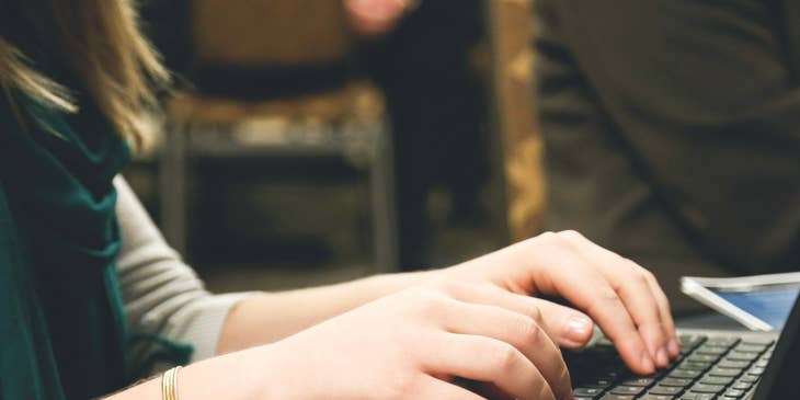 copywriter typing on computer