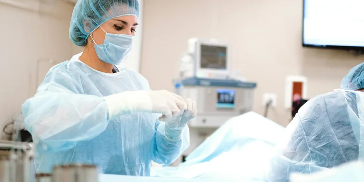 A certified registered nurse anesthetist prepares the medical supplies for the procedure.