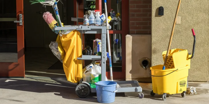 A set of cleaning materials placed outside the building.