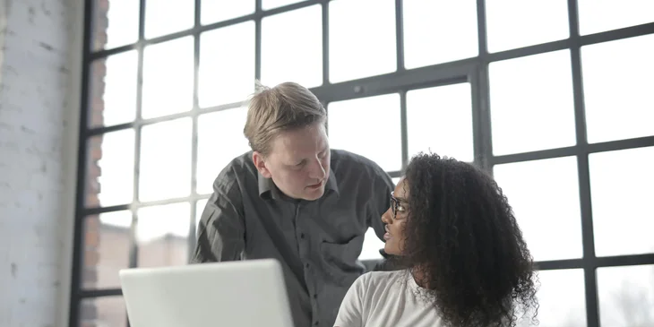 A customer support manager providing insight to a team member.