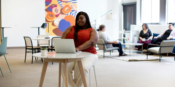 A woman sitting in front of a laptop.