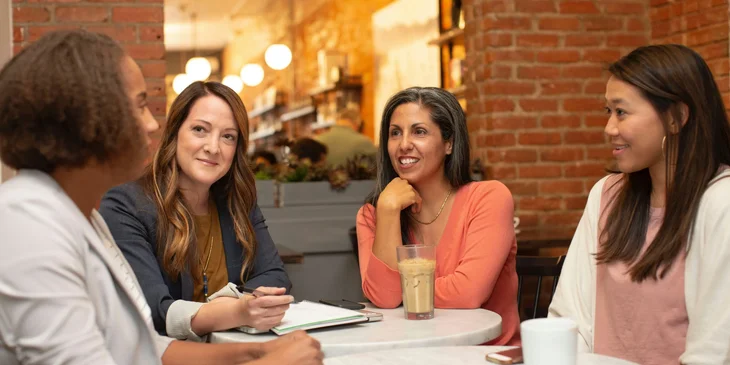 Four women having a meeting.