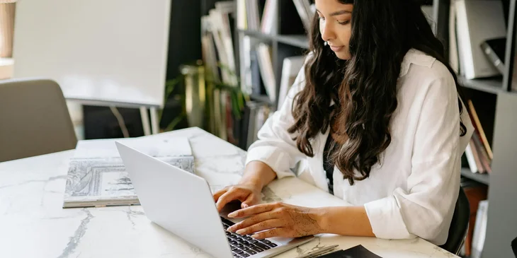 A woman using her laptop in an office.