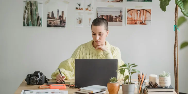 A female designer working on a project using a graphic tablet.