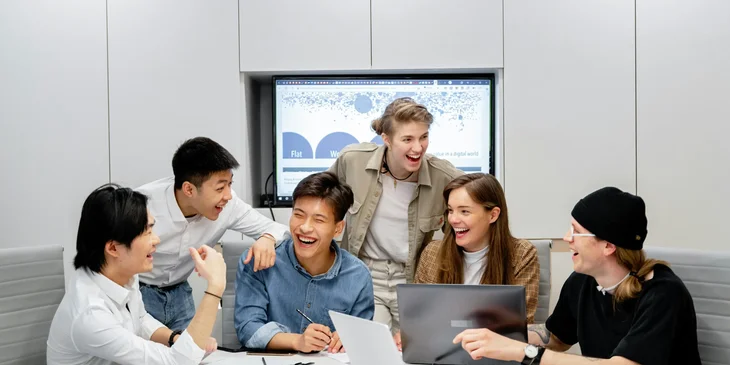 A group of young people having fun during a meeting.