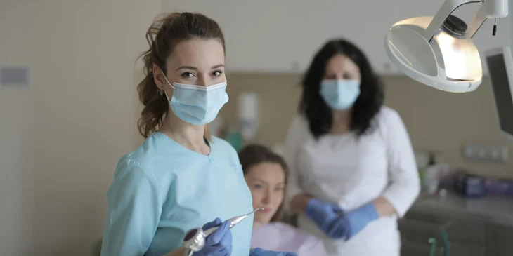 A dedicated dental assistant prepared to support the dentist.