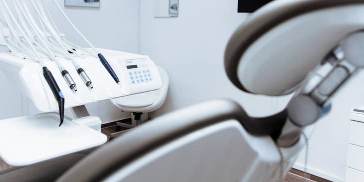 A dental clinic with a dental chair and equipment.