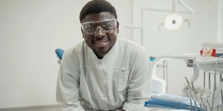 A dentist sitting on a dental chair.
