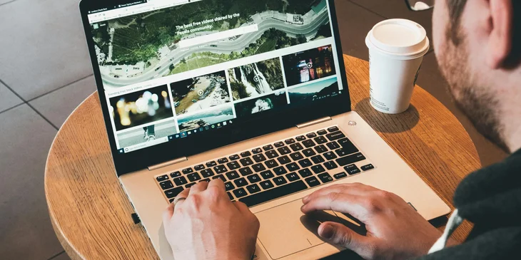 A digital media specialist working on a marketing campaign using his laptop.