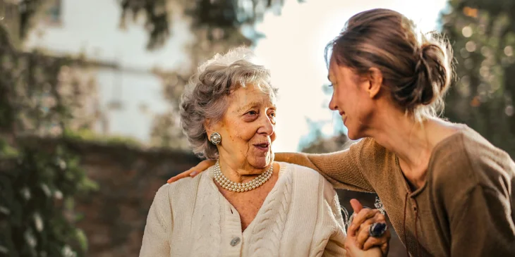 A direct care worker enjoying a conversation with an elderly person in the morning.