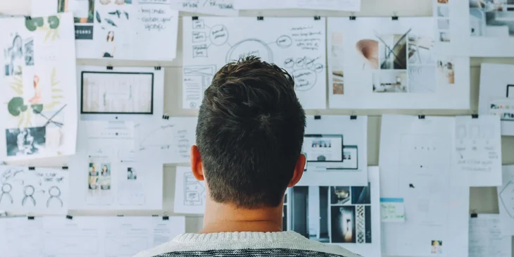 A man examining a disaster recovery plan posted on the wall.