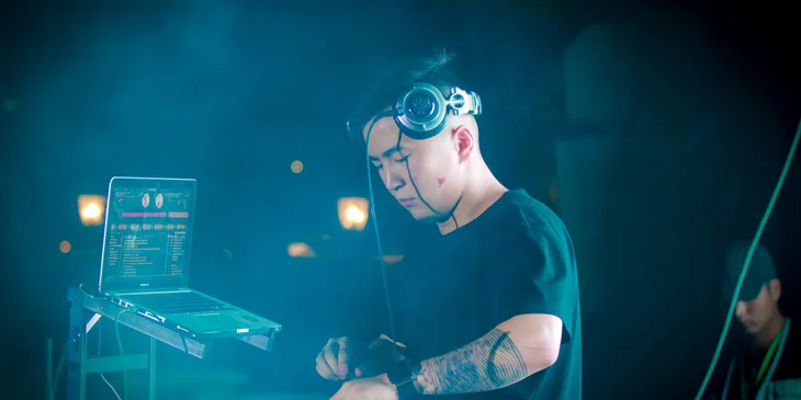 A disc jockey setting up and testing equipment before the show.