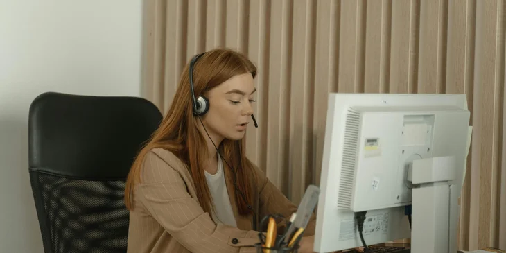 A dispatcher sitting behind a desk, taking calls.