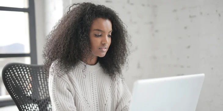 A woman working on her laptop.