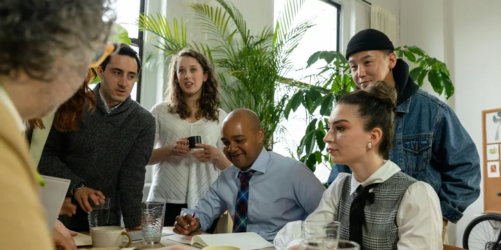 A group of workers from diverse backgrounds having a meeting in the office.
