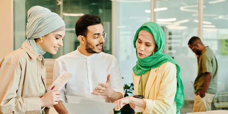 A diverse team of people discussing a project.