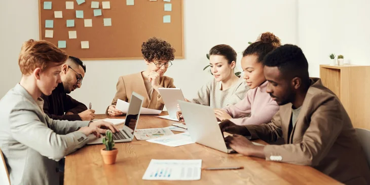 A group of workers from diverse backgrounds having a meeting in the office.