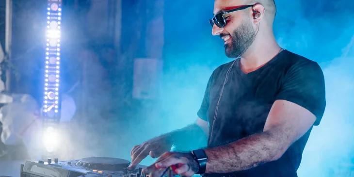 A man playing a dj mixer.