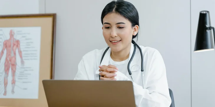A woman using a laptop.