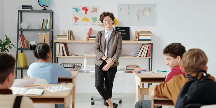 A teacher standing at the front of the classroom.