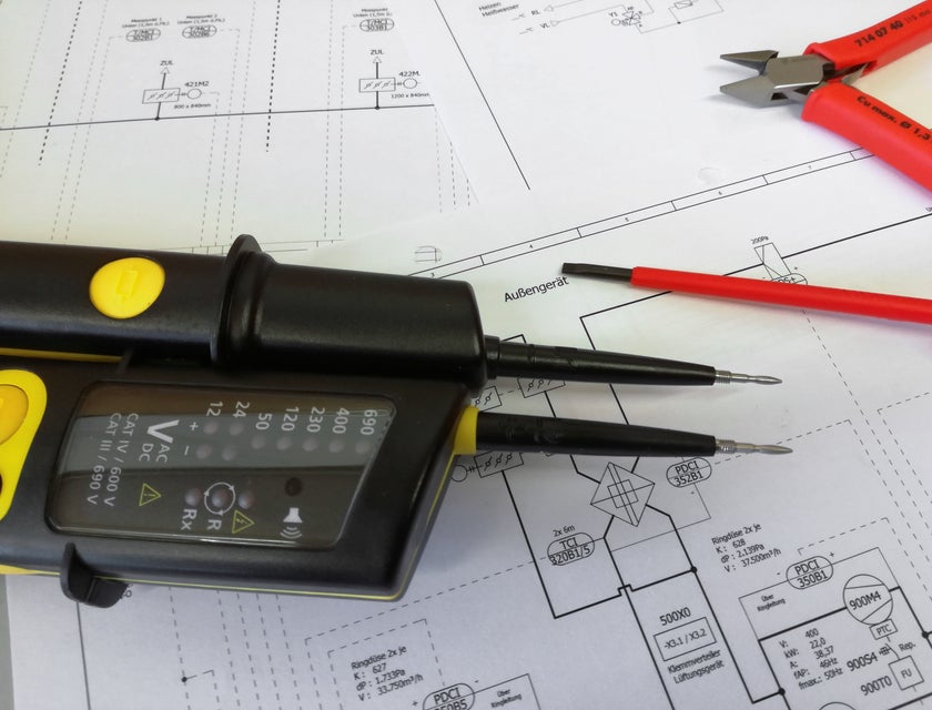 Electrical measurement tools on plans made by an electrical drafter.